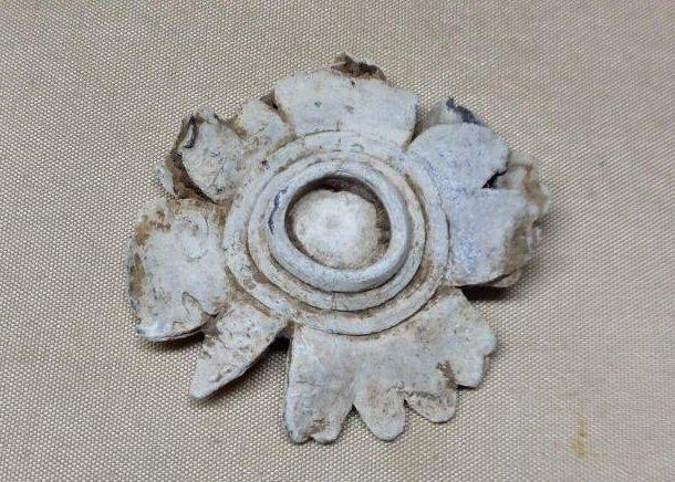A Super Unique Pair of Three-Ringers, mashed together by a soldier, and then carved to apparently resemble a flower in bloom.