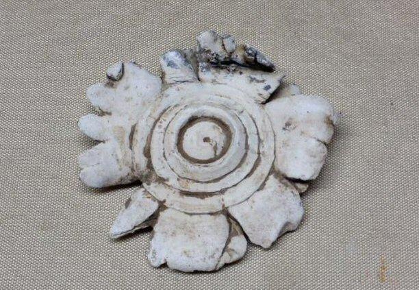 A Super Unique Pair of Three-Ringers, mashed together by a soldier, and then carved to apparently resemble a flower in bloom.